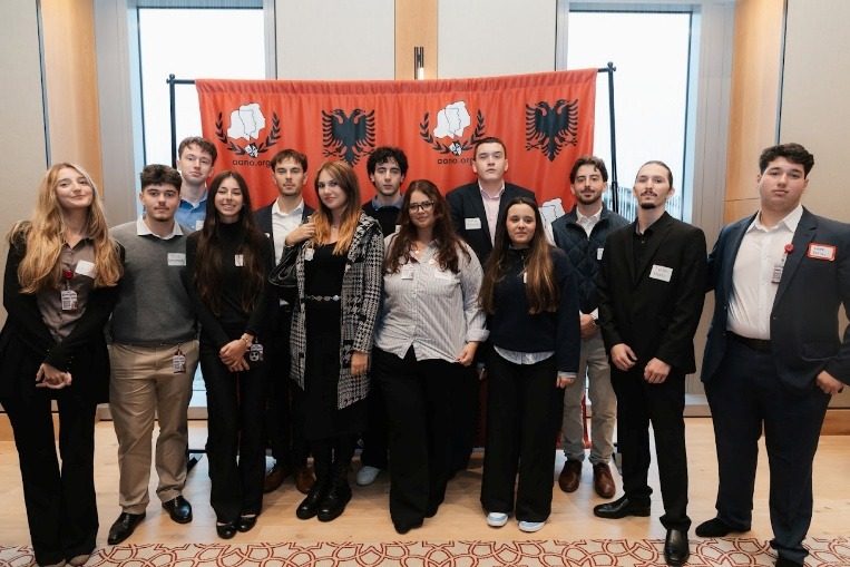 Students standing together by the windows of the Fordham hall.