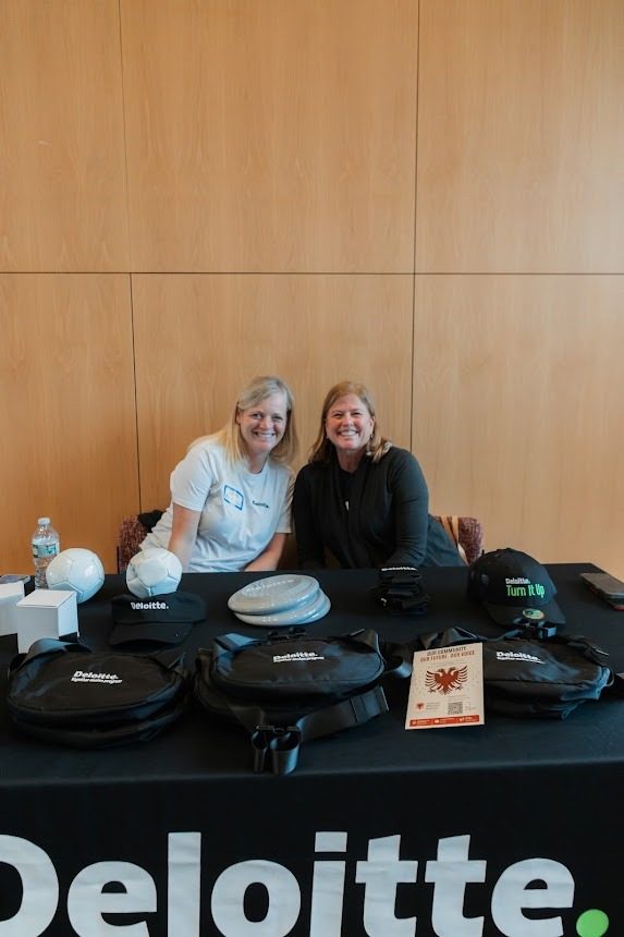 Deloitte representatives at their sponsor table.