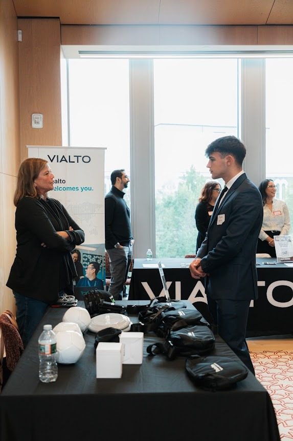 The Vialto Partners table, with representatives talking to a student.