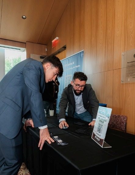 Two sponsors at their table with a QR scan card set out for students.