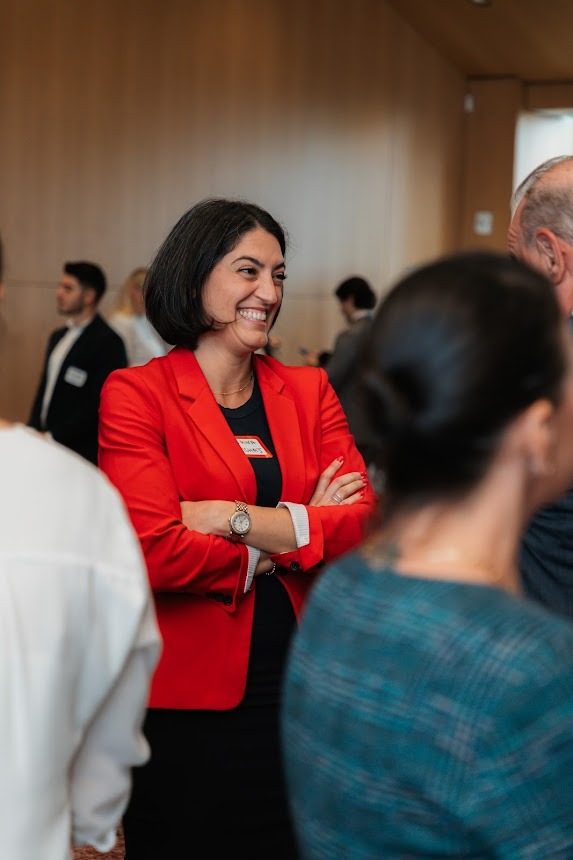 A professional in conversation with students during the networking portion of the day.