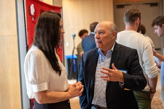 A professional in conversation with a student during the networking break.