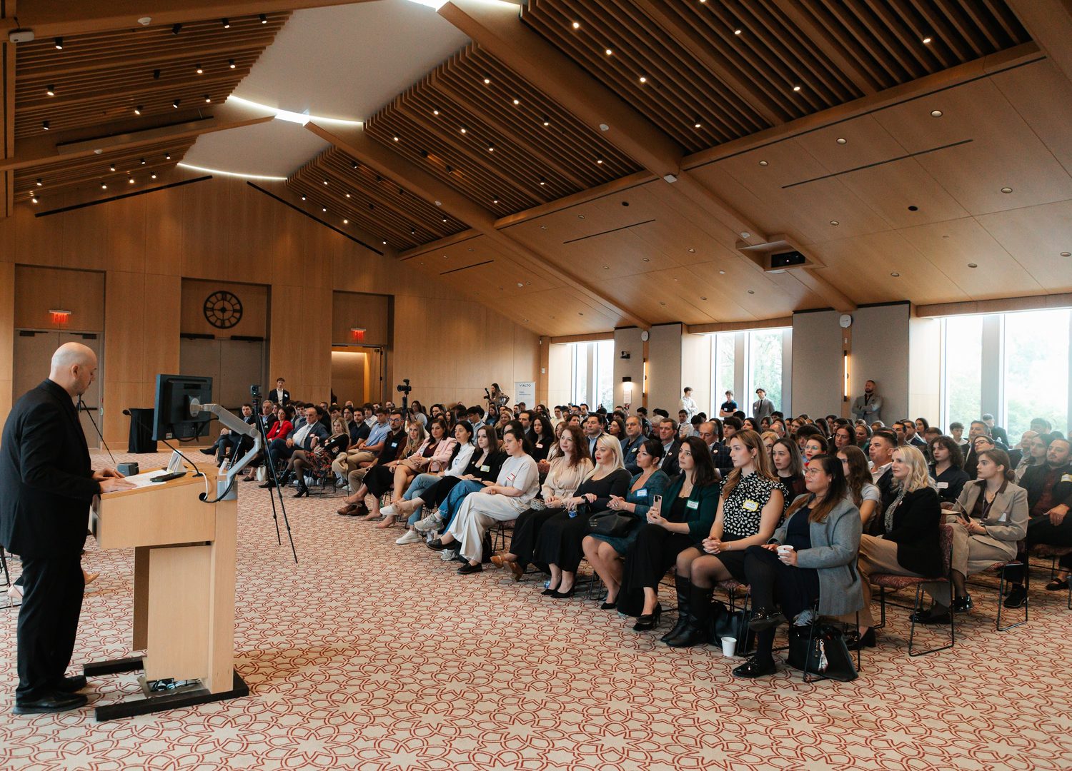 The full hall seen from the lectern, with every row occupied.