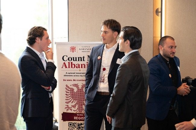 Attendees beside the National Albanian Registry banner.