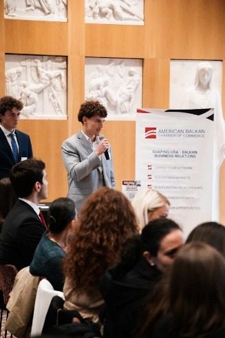 Attendees beside the American Balkan Chamber of Commerce banner.