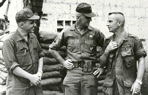 Charles C. Moskos (left) speaking with US Army personnel during a 1967 trip to Vietnam.