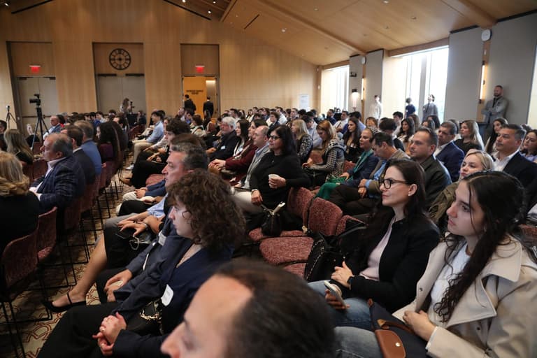 Students and professionals seated in rows for the opening of the Summit.